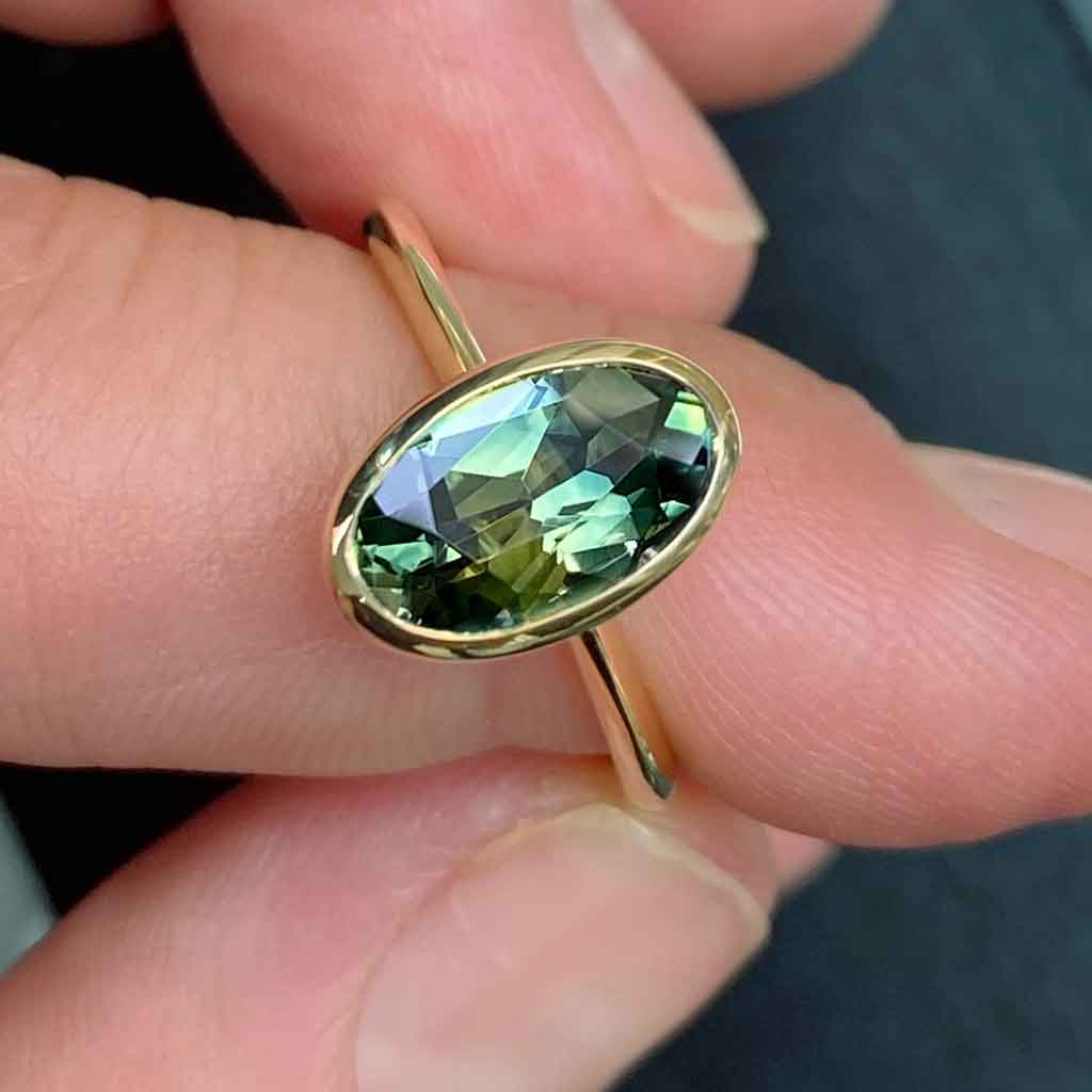 Bezel set oval Australian green teal sapphire engagement ring, Sydney jeweller Lizunova