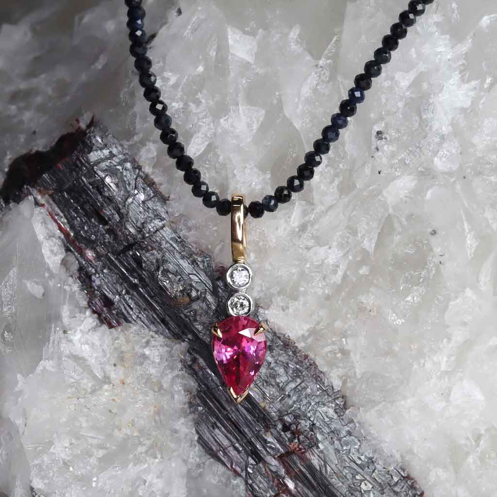 Pink spinel and diamond pendant in 18k rose and white gold, suspended on a natural sapphire strand