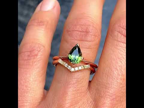 Australian pear cut teal sapphire engagement ring paired with a V shaped diamond wedding ring, by Sydney jeweller Lizunova Fine Jewels, Australia
