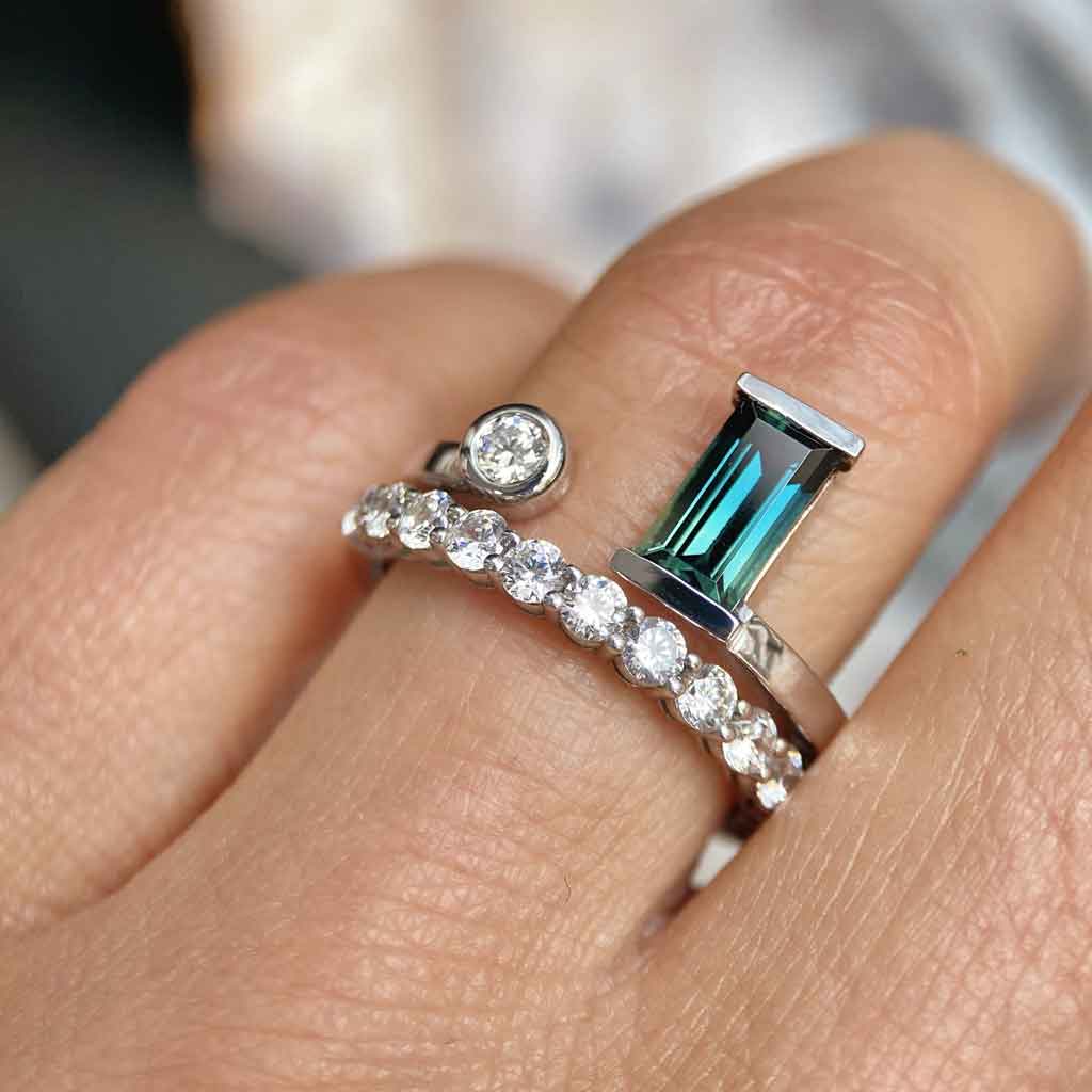 Australian teal sapphire and diamond toi et moi ring stacked with a round diamond wedding band, by Sydney jeweller Lizunova