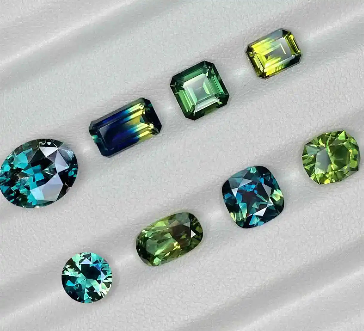 Teal, parti and green Australian sapphires in oval, emerald cut, asscher cut, round, barion and cushion shapes, by bespoke Australian jeweller Lizunova Fine Jewels, Sydney