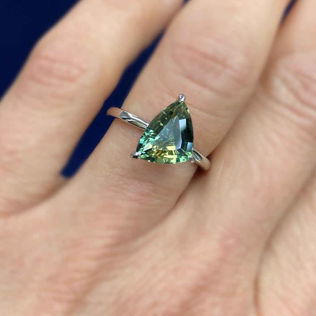 Freeform asymmetric Australian parti sapphire engagement ring with a hidden diamond halo by Lizunova Fine Jewels