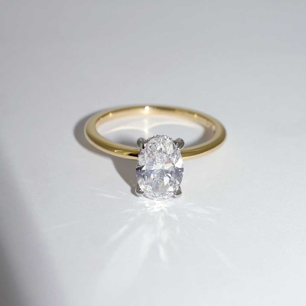 Billie | Oval diamond engagement ring with a hidden halo