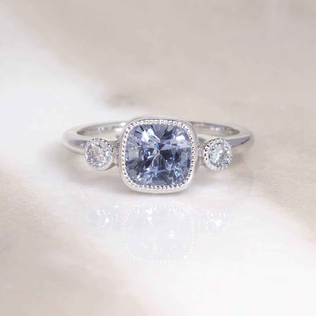 Cushion cut grey spinel diamond trilogy engagement ring in 18k white gold with milgrain detail, handcrafted in Sydney by jeweller Lizunova