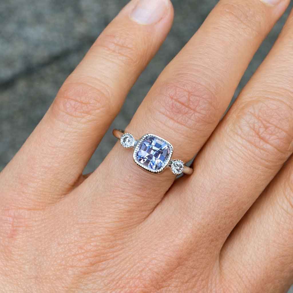 Cushion cut grey spinel diamond trilogy engagement ring in 18k white gold with milgrain detail, handcrafted in Sydney by jeweller Lizunova